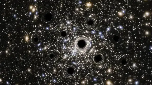 Hubble detecta grupo de buracos negros no centro de uma galáxia